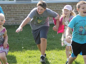 First graders Layla Broumpton, left, and Brayden Atkinson run from Baylee Morrison, Grade 7, and Layla Murray, Grade 1, during a game of chain tag at Hanna Memorial school Friday. The game was one of several students played as part of this week's Fitness Friday. (Tyler Kula/Sarnia Observer/Postmedia Network)