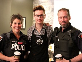 Kingston Police officers Sarah Groenewegen (left) and Steve Koopman (right), seen here with Joel Thompson (centre), visited Crave Coffee House on Thursday May 19 2016 to have a coffee and an informal chat with members of the Kingston community. Jane Willsie/The Kingston Whig-Standard/Postmedia Network