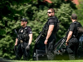 Secret Service agents stands on the North Lawn of the White House in Washington, Friday, May 20, 2016, after the White House was placed on security alert after shooting on street outside. (AP Photo/Andrew Harnik)