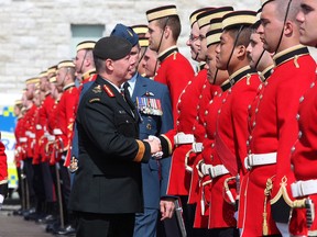 Chief of Defence Staff Jonathan Vance shakes hands with officer-cadets with Chief Warrant Officer Kevin West, who is the CWO for the Canadian Forces, during the Royal Military College Graduation and Commissioning Parade in Kingston on Friday May 20 2016. A total of 211 Officer-Cadets marked their graduation and commissioning into the Canadian Armed Forces at the parade. Ian MacAlpine /The Whig-Standard/Postmedia Network