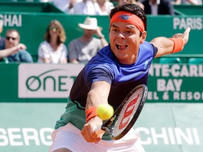 In this April 15, 2016, file photo, Canada’s Milos Raonic returns a shot to Andy Murray during their quarterfinal match at the Monte Carlo tournament in Monaco. (AP Photo/Lionel Cironneau)