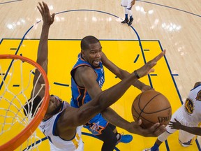 Oklahoma City Thunder forward Kevin Durant (middle) shoots against Golden State Warriors centre Festus Ezeli (left) during Game 2 of the Western conference final at Oracle Arena. (Kyle Terada/USA TODAY Sports)