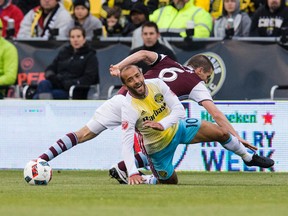 Columbus Crew’s Federico Higuain is knocked to the ground by Colorado Rapids’ Sam Cronin during last week’s 1-1 draw. (USA TODAY SPORTS)