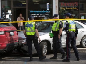 One man who was sitting on a bench on the sidewalk lost at least part of his leg and another person was injured in a multi-vehicle collision on Eglinton Avenue W. and Oakwood Avenue on Friday, May 20, 2016. Stan Behal/Toronto Sun/Postmedia Network