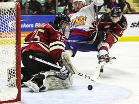 REBELS VS OIL KINGS-- Goaltender Trevor  Martin of the Red Deer Rebels makes a save as  Dario Meyer of the Edmonton Oil Kings and Rebels' forward Jake DeBrusk crash into the net during their WHL tilt at the Enmax Centrium in Red Deer, Alta on Saturday, March 19. The Rebels defeated the Oil Kings 7-2. Photo by Ashli Barrett/Red Deer Advocate