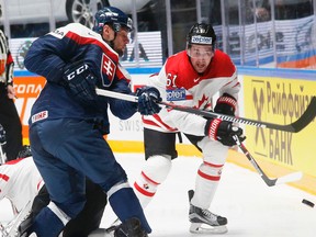 Slovakia’s Ivan Svarny, right, fights for the puck with Canada’s Mark Stone during the world championship. (AP Photo/Dmitri Lovetsky)