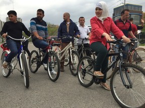 Syrian refugees try out their donated bikes in London on Saturday. John Miner/Postmedia Network