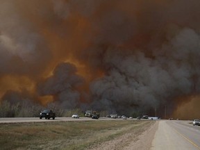 Vehicles head out of Fort McMurray on Highway 63 on May 4 as the city is evacuated. Re-entry to the community will begin June 1 and is expected to be completed by June 15. - Photo by Robert Murray Postmedia