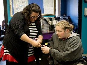 Stony Plain MLA Erin Babcock hands 13-year-old Kaylee McCurdy her card at the Stony Plain Youth Centre in Stony Plain on Friday, May 13, 2016. Babcock visited the centre to speak to youth about her role in the legislature.  - Photo by Yasmin Mayne