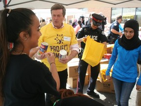 Mayor John Tory helps pack food bags for Project Ramadan at the Scarborough offices of the  Muslim Welfare Centre of Toronto on Saturday. The initiative, which is carried out during the run-up to the Islamic holy month of Ramadan, will send food to the needy via various aid agencies. (Terry Davidson/Toronto Sun)