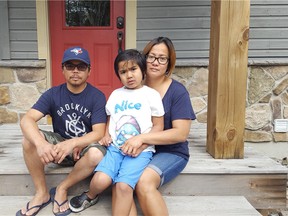 Clint and Melanie Palaypayon sit with their autistic son, Xavier, 6. Their local MPP Bob Delaney's office complained to police and two officers visited their Mississauga home after Melanie told the office staffers she planned to hold a solo protest over the province's new autism rules. (Supplied)