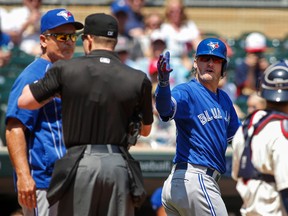 Toronto Blue Jays third baseman Josh Donaldson (20) reacts to umpire Toby Basner who speaks with manager John Gibbons after he threw Donaldson out of the game in the first inning at Target Field May 21, 2016 in Minneapolis. (Bruce Kluckhohn-USA TODAY Sports)