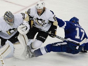 Tampa Bay Lightning centre Alex Killorn (17) slides into Pittsburgh Penguins left wing Carl Hagelin (62) and Penguins goalie Marc-Andre Fleury (29) during the third period in game four of the Eastern Conference Final of the 2016 Stanley Cup Playoffs at Amalie Arena. (Reinhold Matay-USA TODAY Sports)
