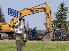 A backyard fort, shed, and a roadside mailbox are all that is left after a fire burned down a house with a 37-year-old woman inside at 31222 Edinborough Line near Dutton, Ont. on Sunday May 22, 2016. An OPP officer patrolling on nearby Hwy. 401 noticed the fire about 4 a.m. Saturday morning.  There is no evidence the fire was set deliberately, however the Ontario Fire Marshal is investigating.  Craig Glover/The London Free Press/Postmedia Network