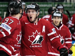 Canada’s Matt Duchene, center, reacts as Connor McDavid, left, scored the first goal during the Ice Hockey World Championships final match between Finland and Canada, in Moscow, Russia, on Sunday, May 22, 2016. (AP Photo/Pavel Golovkin)