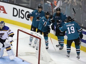 Joe Pavelski of the San Jose Sharks celebrates after scoring with Tomas Hertl, Joe Thornton and Brent Burns #88 in game four of the Western Conference Finals against the St. Louis Blues during the 2016 NHL Stanley Cup Playoffs at SAP Center on May 21, 2016 in San Jose, California.  (Sean M. Haffey/Getty Images/AFP)