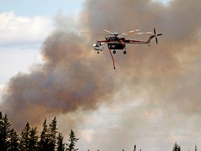 A helicopter battles a wildfire south of Fort McMurray, Alberta on May 8, 2016.
