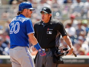 Toronto Blue Jays third baseman Josh Donaldson, left, argues with umpire Mark Ripperger about a close pitch by the Minnesota Twins in the fifth inning of a baseball game Sunday, May 22, 2016, in Minneapolis. (AP Photo/Bruce Kluckhohn)