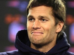 New England Patriots quarterback Tom Brady smiles while facing reporters before a scheduled NFL football practice, Wednesday, Jan. 6, 2016, in Foxborough, Mass. The Patriots are to host an NFL divisional playoff game Jan. 16, 2016,  in Foxborough, Mass.  (AP Photo/Steven Senne)