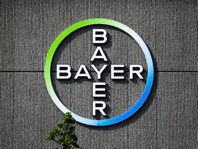 The Bayer AG corporate logo is displayed on a building of the German drug and chemicals company in Berlin, Germany, Monday, May 23, 2016. German drug and chemicals company Bayer AG announced Monday, May 23, 2016 that it has made a US$ 62 billion offer to buy U.S.-based crops and seeds specialist Monsanto. The proposed combination would create a giant seed and farm chemical company with a strong presence in the U.S., Europe and Asia. (AP Photo/Markus Schreiber)
