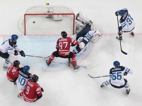 Canada’s Connor McDavid, center, scores against Finland’s goalie Mikko Koskinen during the Hockey World Championships final match between Finland and Canada, in Moscow, Russia, on Sunday, May 22, 2016. (AP Photo/Ivan Sekretarev)