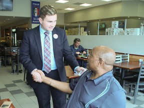 Michael Ford greets Ward 2 residents while campaigning in the byelection to replace his uncle Rob Ford on coucil for Etobicoke-North. (Veronica Henri/Toronto Sun)