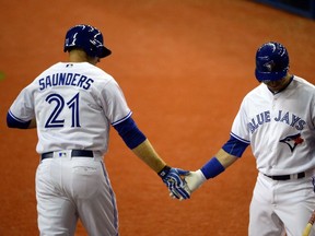 Toronto Blue Jays outfielder Michael Saunders celebrates with teammate Justin Smoak after hitting a homerun during the second inning against the Boston Red Sox at Olympic Stadium. (Eric Bolte/USA TODAY Sports)