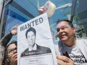 Bruce McIntosh. president of the Ontario Autism Coalition, gets some help from Angelina Palmisano posting Wanted posters throughout both Ontario Health Minister  Erik Hoskins' and MPP Michael Colle's ridings Monday May 23, 2016. (Stan Behal/Toronto Sun)