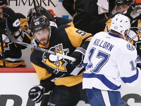 Penguins' Kris Letang (left) and Lightning's Alex Killorn (right) tangle along the boards during Game 1 of the NHL's Eastern Conference final in Pittsburgh on Friday, May 13, 2016. (Gene J. Puskar/AP Photo)