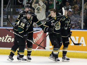 London Knights players Victor Mete (98), Christian Dvorak and Mitch Marner celebrate a goal by line mate Matthew Tkachuk (7) during game 2 of their OHL championship hockey series against the Niagara Ice Dogs at Budweiser Gardens in London, Ont. on Saturday May 7, 2016. The Knights won the game 6-1, taking a 2-0 lead in the series.  Craig Glover/The London Free Press/Postmedia Network