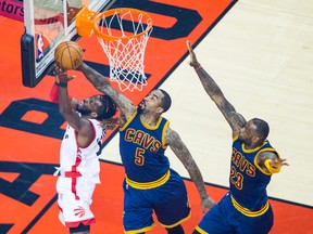 Raptors' DeMarre Carroll (left) goes up for a layup while Cavaliers' J.R. Smith (centre) with LeBron James (right) defend during first half action in Game 4 of the Eastern Conference final in Toronto on Monday, May 23, 2016. (Ernest Doroszuk/Toronto Sun)