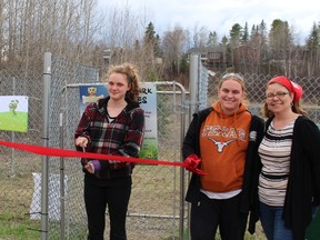 Sara Bernier happily cuts the ribbon to officially open Sara's Freedom Dog Park last week. She is joined by Jessica Stere, Stephanie Bernier, and Kim Sturch.