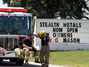 Chatham-Kent firefighters take a break after fighting a fire at Wallaceburg's Stealth Metal Recycling and Processing on Wednesday, May 18.