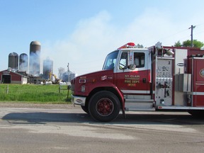 Firefighters pour water on a barn located on Petrolia LineTuesday May 24, 2016 west of Petrolia, Ont. A section of Petrolia Line was closed to traffic Tuesday morning as firefighters from Petrolia, Wyoming and St. Clair Township fought the barn fire. Paul Morden/Sarnia Observer/Postmedia Network