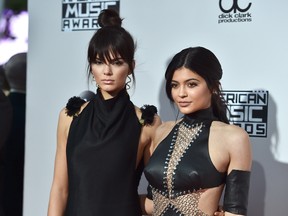 In this Nov. 22, 2015 file photo, Kendall Jenner, left, and Kylie Jenner arrive at the American Music Awards at the Microsoft Theater in Los Angeles. (Photo by Jordan Strauss/Invision/AP, File)