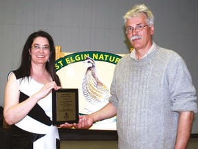 Dianne Dowling, left, president of the West Elgin Nature Club, accepts a plaque from West Elgin Mayor Bernie Wiehle congratulating the club on its 70th anniversary.