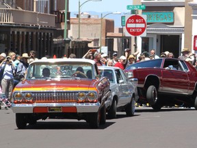This May 22, 2016 photo shows lowriders parading around the historic plaza in Santa Fe, N.M., as part of the city's Lowrider Summer celebration. The New Mexico History Museum and the New Mexico Museum of Art also are hosting exhibitions highlighting the lowrider culture. (AP Photo/Susan Montoya Bryan)