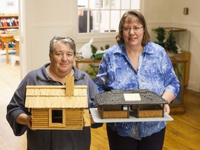 Vermilion Heritage Museum President Jean Murie and Secretary Audrey Chesterman hold replica structures of a rangers cabin and camp kitchen, as part of the Vermilion Provincial Park display. Taylor Hermiston/Vermilion Standard/Postmedia Network.