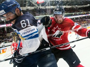 Canada’s Mark Stone fights for the puck with Finland’s Aleksander Barkov during the world hockey championship final in Moscow on May 22, 2016. (AP Photo/Pavel Golovkin