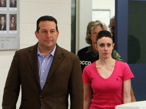 Casey Anthony and her lawyer Jose Baez (L) leave the Orange County Jail in Orlando, Florida July 17, 2011. A private investigator who worked on the case says Anthony paid Baez with sexual favours. REUTERS/Red Huber/Pool