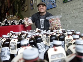 Jeff Pastorius, of the London Brewing Co., holds up some of the rhubarb customers have dropped off to be used in an batch of rhubarb beer at a monthly pop-up shop at The Root Cellar. Customers who brought rhubarb in were given a London Brewing Co. glass in exchange. (CRAIG GLOVER, The London Free Press)