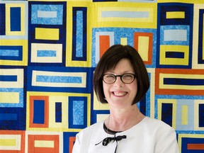 Ailsa Craig Community Quilt Festival and Fibre Art Exhibition chair Cynthia McNair stands in front of a quilt created by Mairita Eglite. The festival runs until Saturday. (CRAIG GLOVER, The London Free Press)