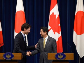 Prime Minister Justin Trudeau (L) shakes hands with his Japanese counterpart Shinzo Abe at their joint news conference at Abe's official residence in Tokyo, Japan, May 24, 2016, ahead of the Ise-Shima G7 summit meetings. REUTERS/Toru Yamanaka/Pool