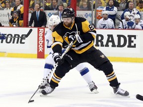 Penguins right wing Phil Kessel (81) carries the puck ahead of Lightning left wing Jonathan Drouin (27) during the NHL's Eastern Conference final in Pittsburgh on May 16, 2016. Kessel and Drouin have become key contributors in the post-season, boosting their chances of playing in the World Cup of Hockey in September. (Charles LeClaire/USA TODAY Sports)