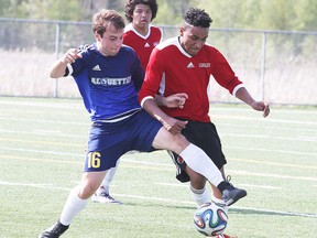 Eric Sampson of the College Notre Dame Alouettes battles for the ball with Tyger Louis of the St. Charles Cardinals during senior boys semi-final high school soccer action in Sudbury, Ont. on Tuesday May 24, 2016. Gino Donato/Sudbury Star/Postmedia Network
