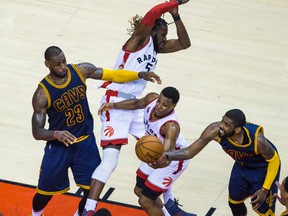 Raptors' Kyle Lowry (bottom) with DeMarre Carroll (top) and Cavaliers LeBron James (left) and Kyrie Irving (right) battle for the ball during fourth quarter action in Game 4 of the Eastern Conference final in Toronto on Monday, May 23, 2016. (Ernest Doroszuk/Toronto Sun)