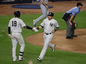 New York Yankees' Carlos Beltran, right, is greeted by Didi Gregorius after scoring on a sacrifice fly by Chase Headley against the Toronto Blue Jays during the eighth inning of a baseball game, Tuesday, May 24, 2016, in New York. The Yankees won 6-0. (AP Photo/Julie Jacobson)