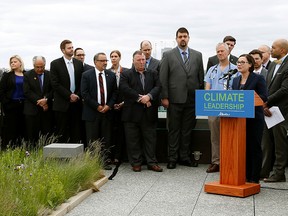 Shannon Phillips (at podium/Alberta Minister Responsible for the Climate Change Office) introduced Bill 20, the Climate Leadership Implementation Act, on the roof of the Federal Building in Edmonton on May 24, 2016. (Larry Wong photo)
