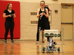 A group of physics students at Central Huron Secondary School have a good laugh while testing their robot prior to the start of a class competition on May 20. The Grade 12 students had spent the past few months designing and building their robots for this challenge. (Photo taken by Justin Prince)
