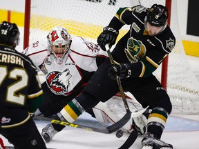 Rouyn-Noranda Huskies goalie Chase Marchan, left, looks on as London Knights' Matthew Tkachuk tries for a rebound during second period CHL Memorial Cup hockey action in Red Deer, Tuesday. (THE CANADIAN PRESS)